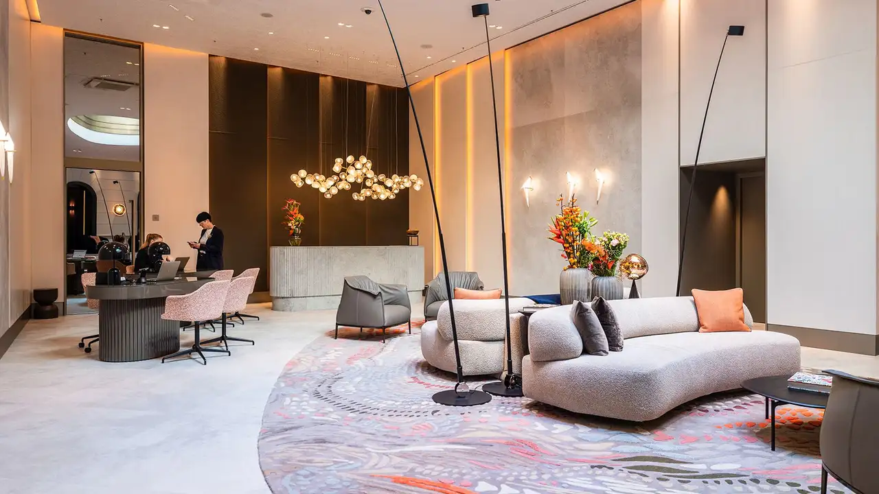 View of the warmly lit, stylish lobby of the Steinberger Hotel in Baden-Baden, Germany