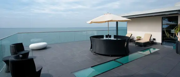 View of the sea from a roof terrace with lounge furniture
