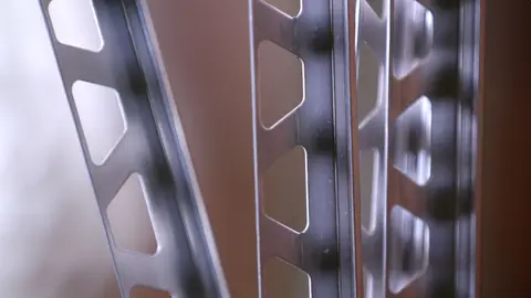 Close-up of the anchoring legs of four stainless steel versions of the Schlüter-SCHIENE finishing profile