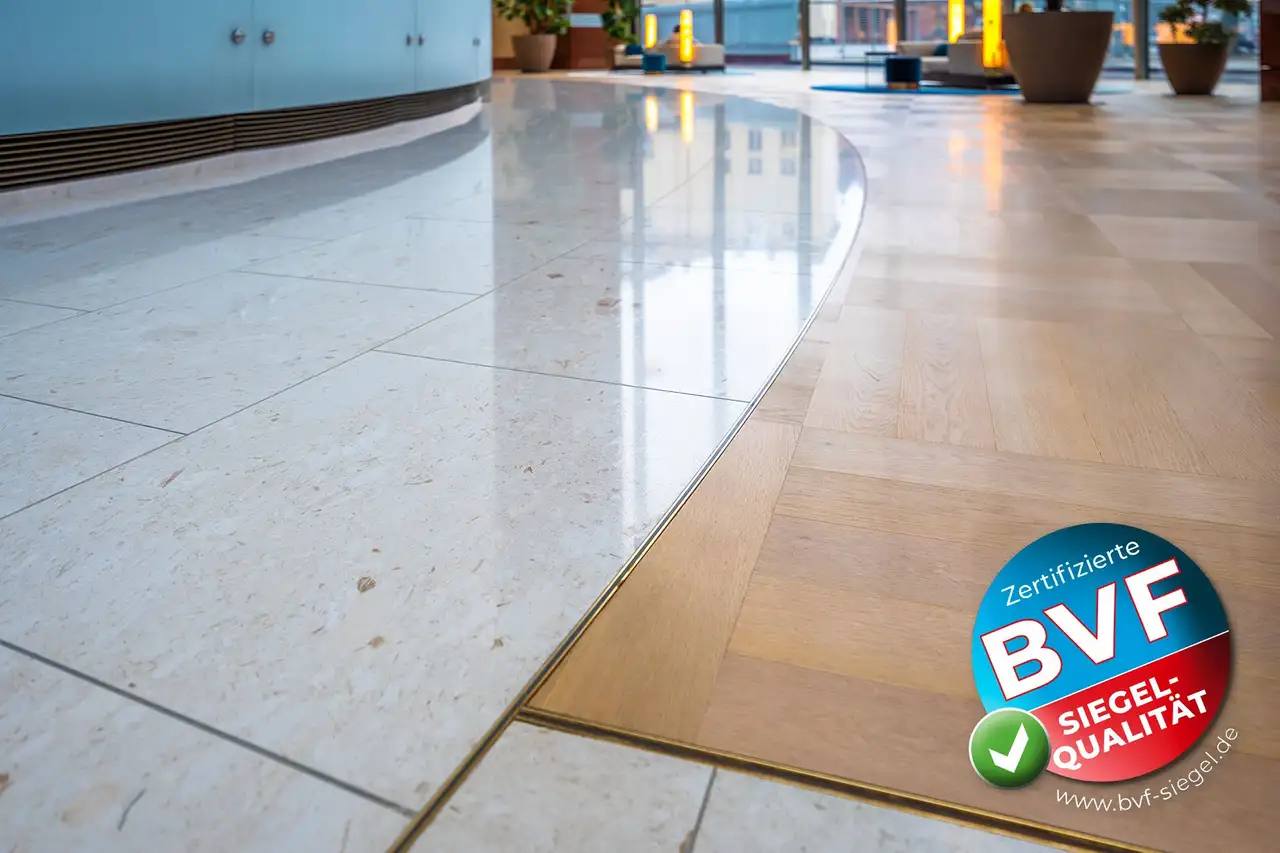 Tiled floor area in the lobby of the Frankfurt Messeturm, bottom right: BVF Award logo