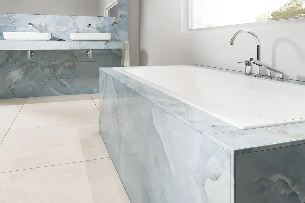 Tiled bathtub with printed edge profiles that blend in with the style of the tiles