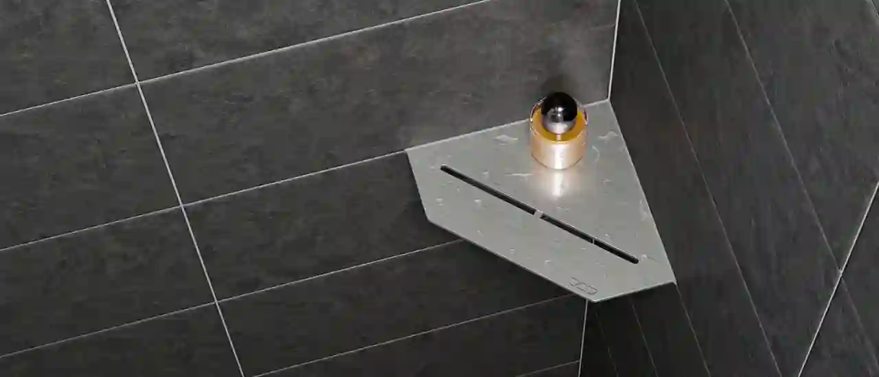Close-up of a Schlüter-SHELF-E-S2 shower corner shelf in PURE design on dark grey tiled walls