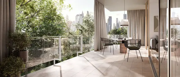A modern, furnished balcony with large, sand-coloured natural stone pavers