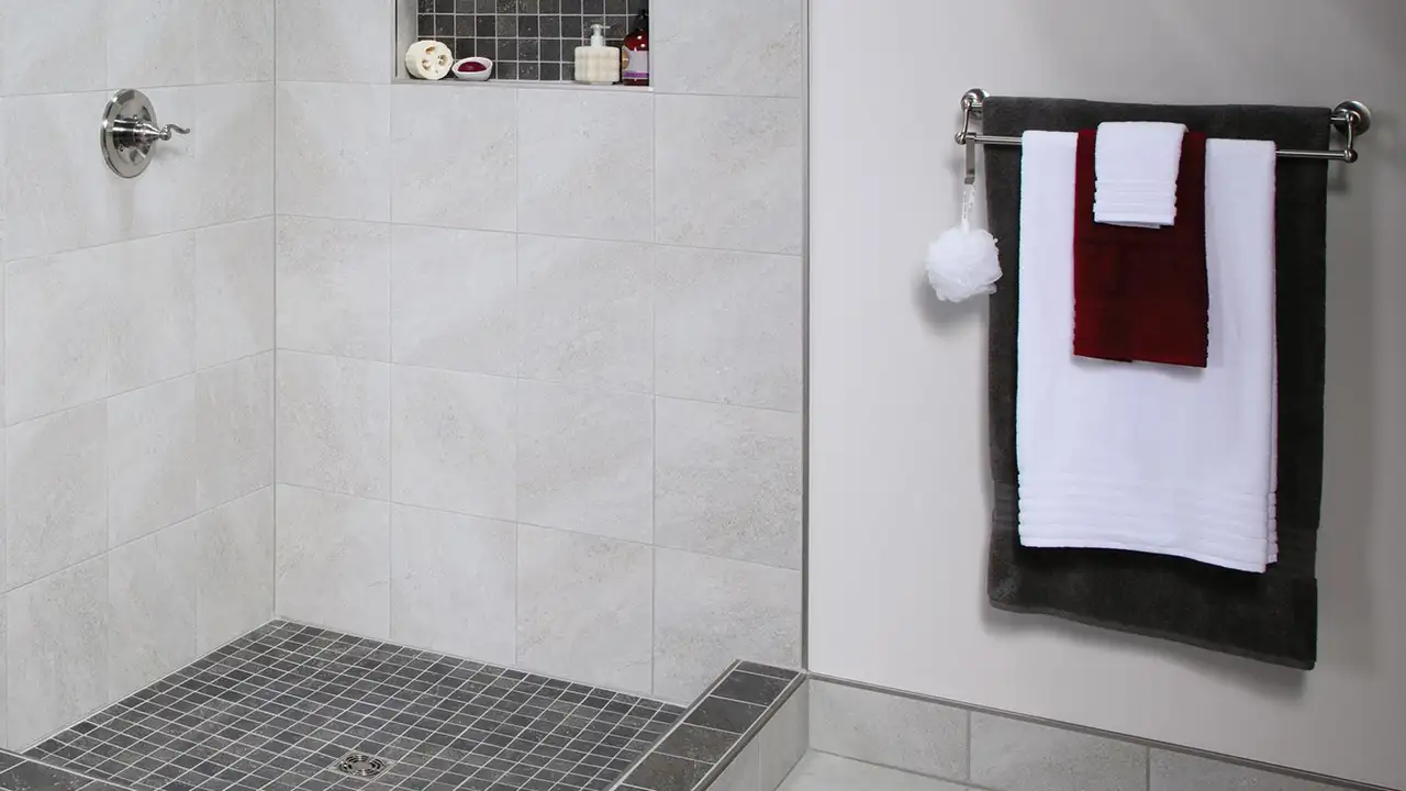 Walk-in shower and wall-mounted towel rail as places to use the electric floor heating system.