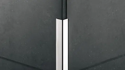 Corner profile subsequently glued onto a black tiled external corner