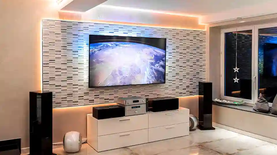 View of the multimedia area in the living room in front of a large illuminated wall panel