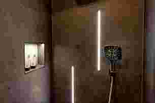 Shower with LIPROTEC cove lighting and KERDI-BOARD-NLT illuminated niche.