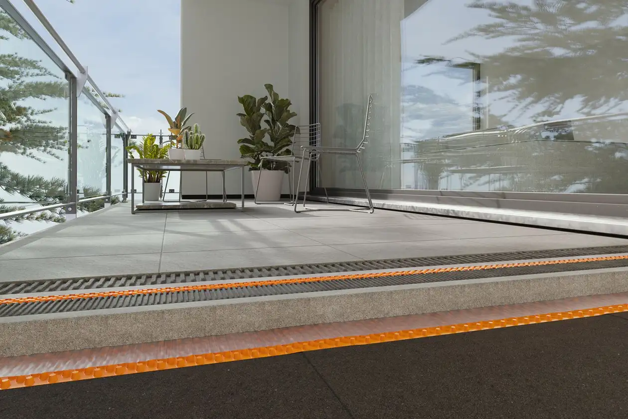 Hell gefliester Balkon, im Hintergrund ein Pflanzen-Arrangement, im Vordergrund ein Schnittbild, das den Aufbau unter dem Balkon darstellt