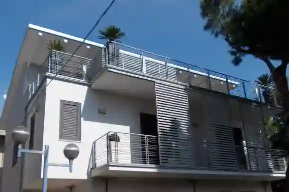 Außenansicht eines Hauses mit zwei Balkonen, wo das Rinnensystem Schlüter-BARIN verbaut ist.
