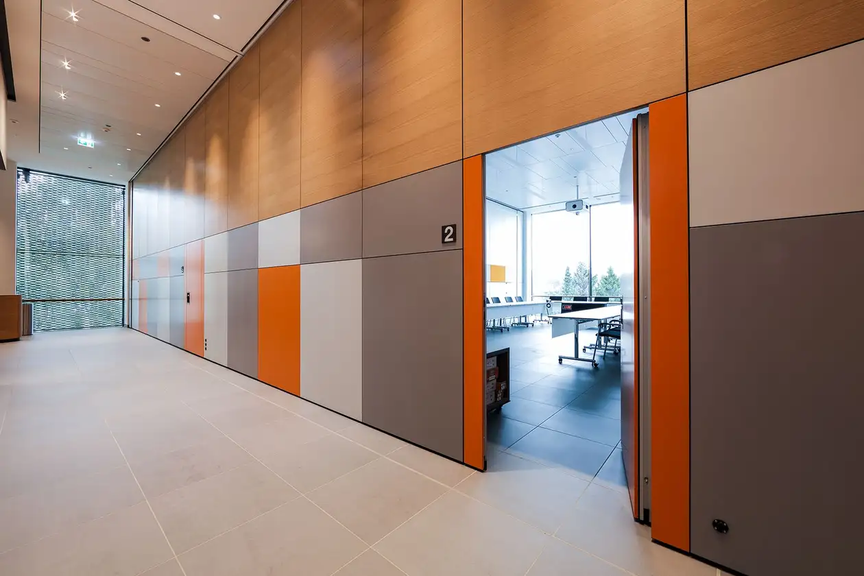 Couloir de la WorkBox avec vue libre sur la salle de s&eacute;minaire via une porte ouverte