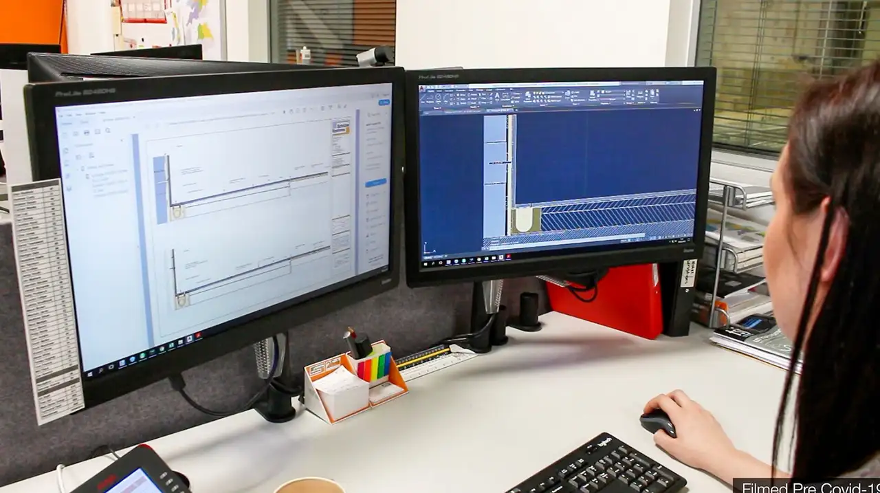 Computer screens showing technical drawings 