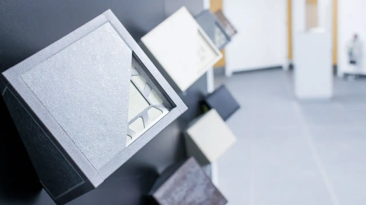 Close up of tile trims with tile corner cut out to expose the anchoring legs