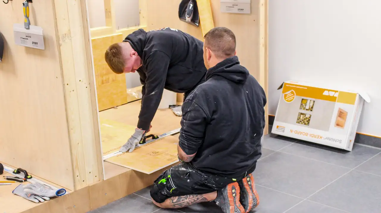 Two installers at the Schlüter-Systems Ltd training centre, learning how to use our products