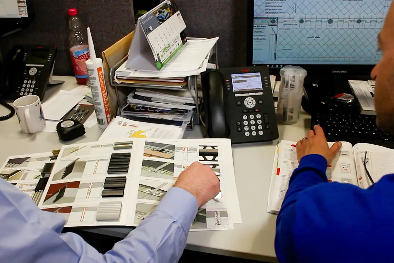 View of a desk with two people in discussion
