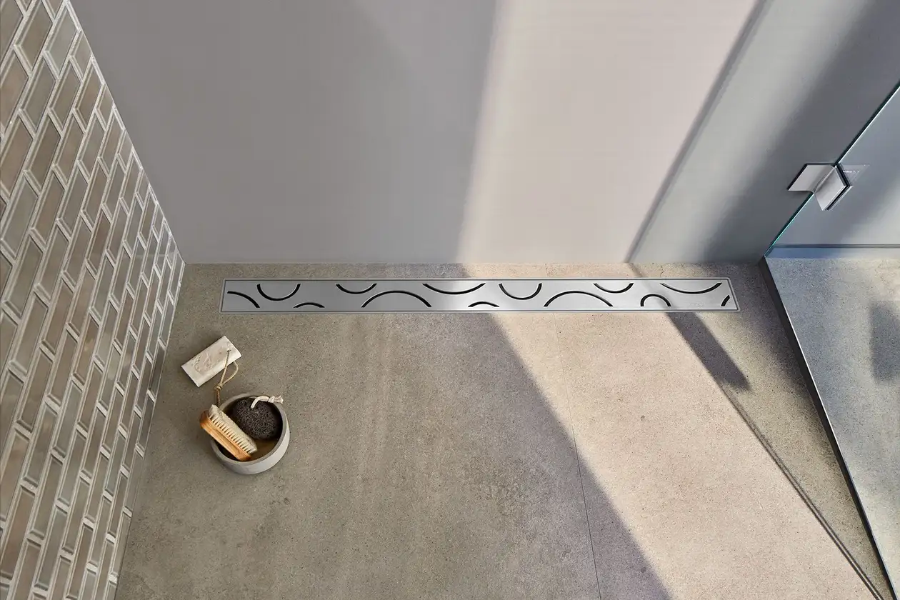 Birdseye view of patterned stainless steel wetroom shower drain
