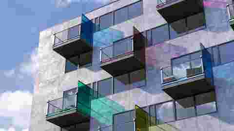 External facade of a building with colourfully coated balcony edge profiles