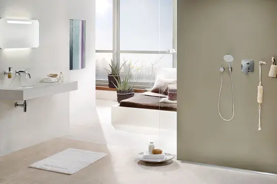 En-suite bathroom with open shower, window front and bed in the background