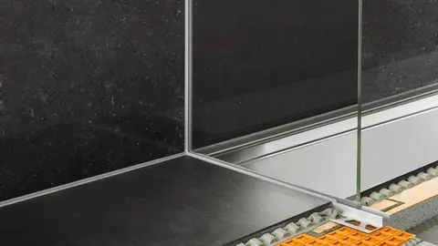 Glass wall in a tiled shower, mounted in a profile on the wall and floor