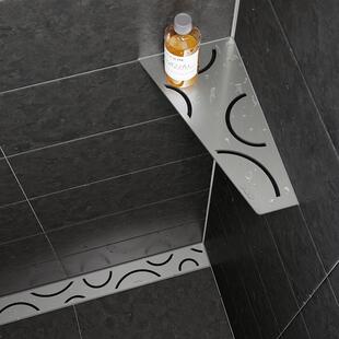 Schlüter-SHELF-E shower shelf and Schlüter-KERDI-LINE shower channel, both in brushed stainless steel in the FLORAL design