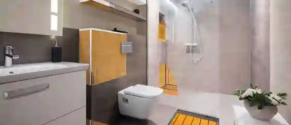 Modern, bright bathroom with partially visible Schlüter-Systems products such as KERDI waterproofing and DITRA-HEAT underfloor heating under the tiled surfaces.