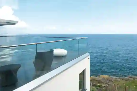 Terrace of a house by the coast, with railings and finishing edge in stainless steel