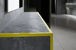 Gradino con rivestimento in ceramica grigia e bordo a contrasto giallo.