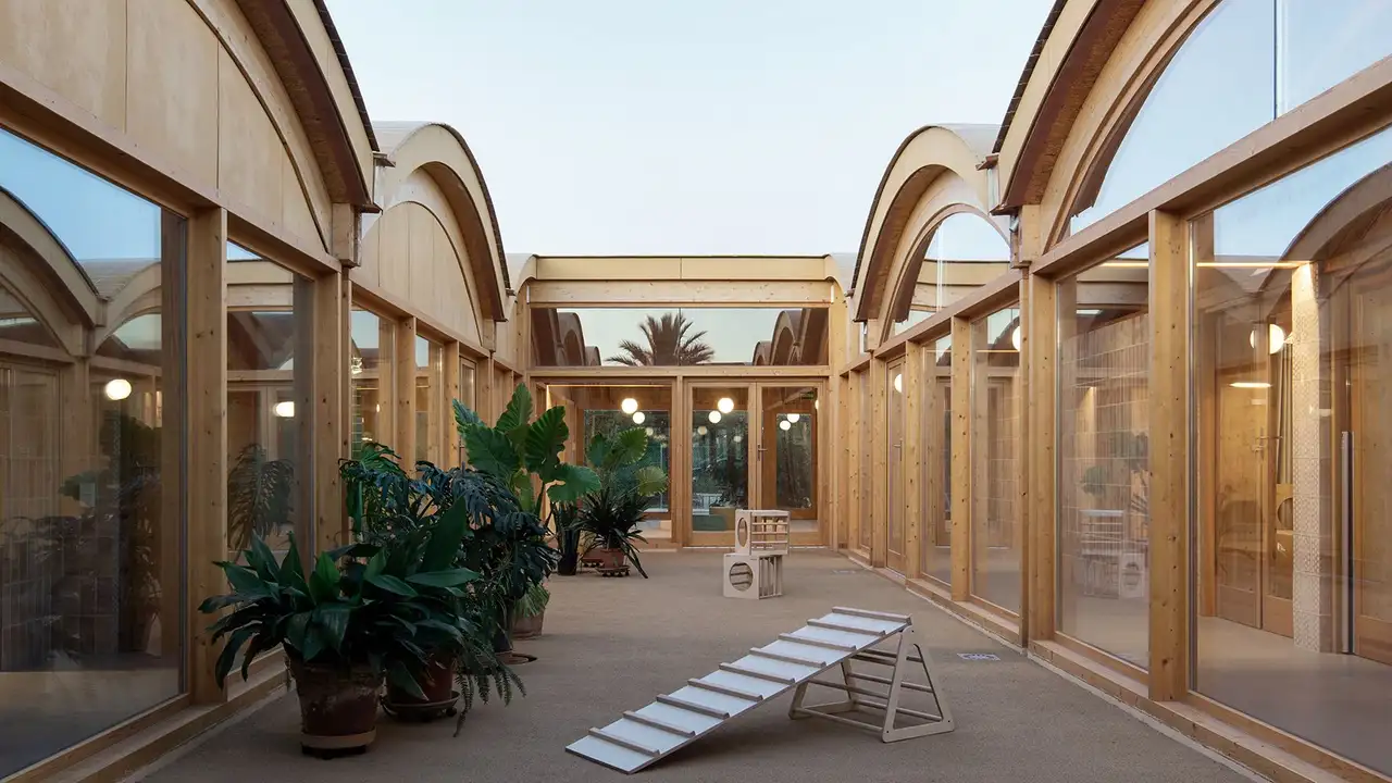 P&aacute;tio interior da creche em Muro, em Maiorca (Espanha), com jogos infantis de madeira e plantas grandes