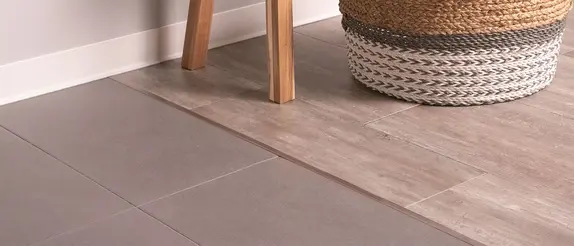 Detaljerad bild p&aring; &ouml;verg&aring;ngsprofilen Schl&uuml;ter-VINPRO-T visar anslutningen mellan intilliggande golvbel&auml;ggningar.
