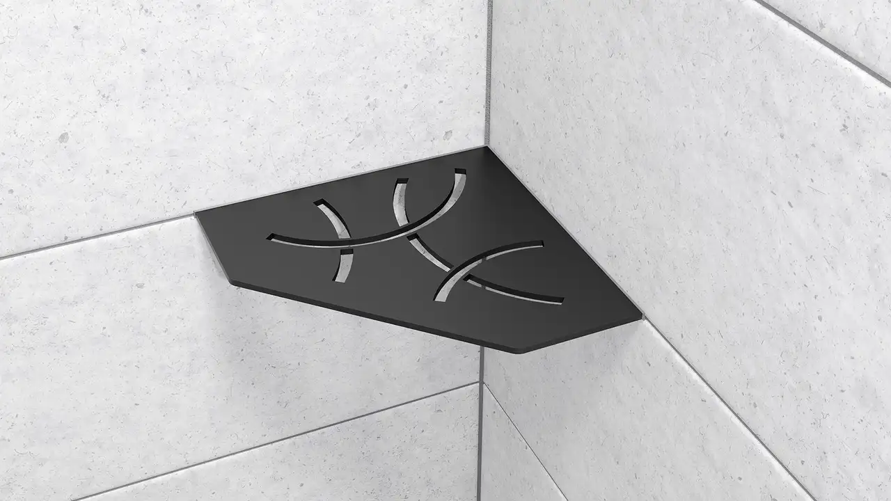 H&auml;r visas en produktn&auml;rbild p&aring; duschh&ouml;rnhyllan Schl&uuml;ter-SHELF-E-S2 i form av en beskuren kvadrat i designen CURVE i f&auml;rgen MGS grafitsvart matt installerad p&aring; ljusgr&aring;tt v&auml;ggkakel